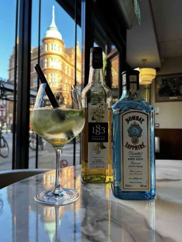 Bombay Sapphire Drink next to Elderflower Syrup and Cocktail